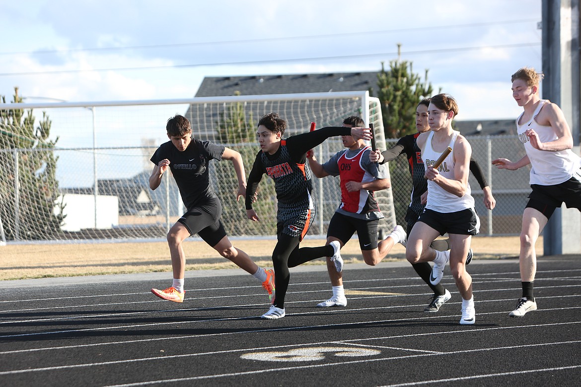 Runners hand off the baton during an event at the Best of the Basin track and field meet at Quincy High School.