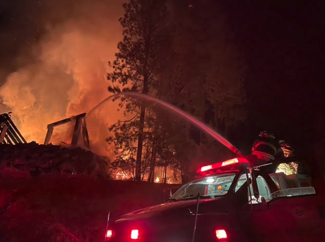 East Side Fire District firefighters battle flames Monday night at Gozzer Ranch.