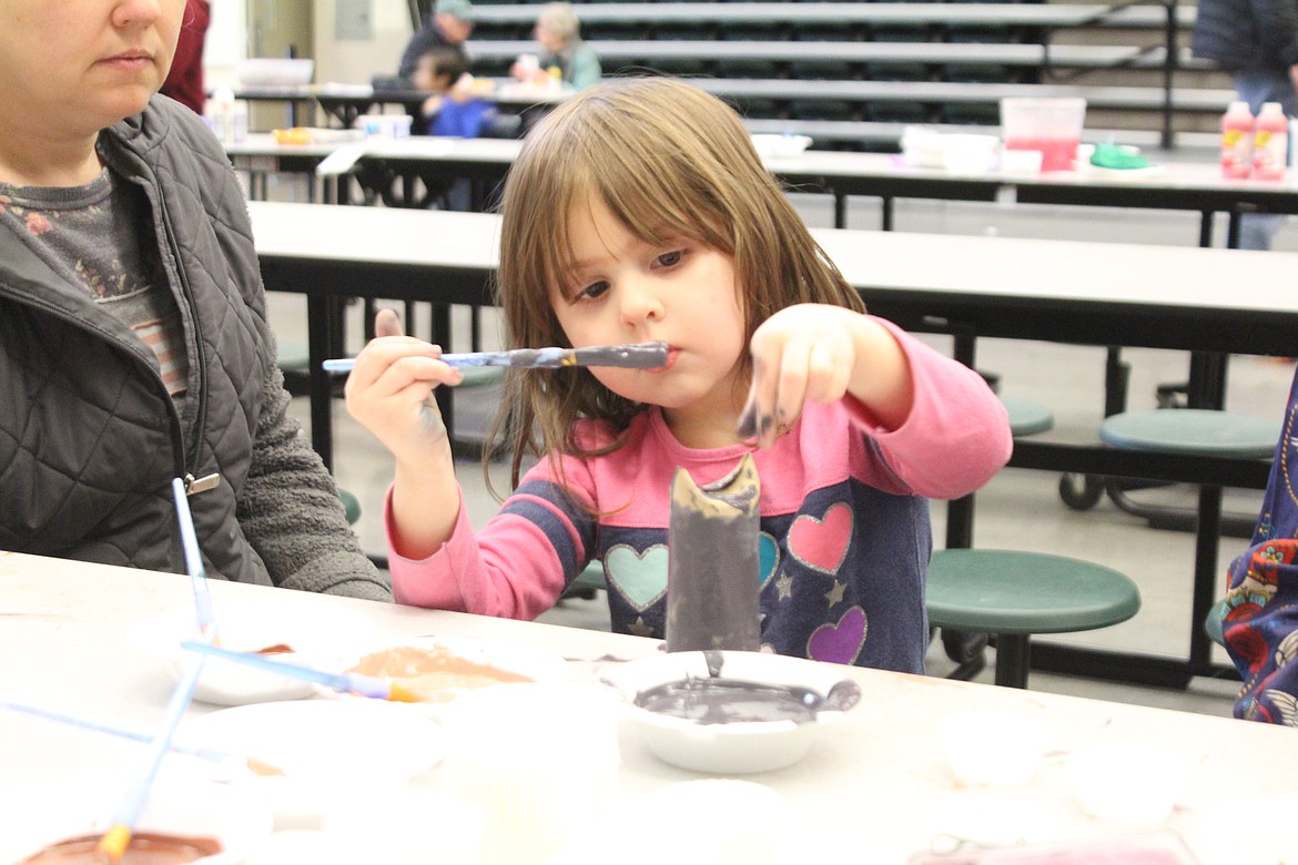 Adyra Flores concentrates on her painting while working on bird-themed craft for children at the Othello Sandhill Crane Festival.