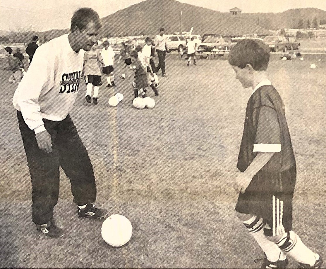 Coach Bill Eisenwinter is shown with Kyle Kohli, 10, at a soccer camp April 1, 1998.