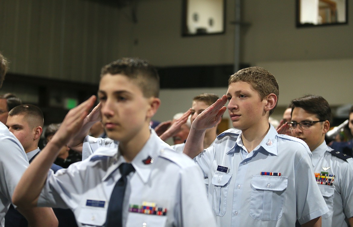 From left, Civil Air Patrol cadets C/TSgt Spencer Slater, C/SrA Landon Hart and C/1stLt Jeremy Abegg-Guzman salute the incoming Coeur d'Alene Composite Squadron commander Tuesday night during a change of command ceremony.