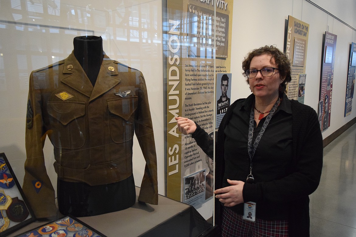 Moses Lake Museum and Art Center Director Dollie Boys stands next to an authentic U.S. Army World War II-era “Eisenhower Jacket,” one of the exhibits on display as part of the Washington Remembers WWII, a Legacy Exhibit currently at the Moses Lake Museum and Art Center.