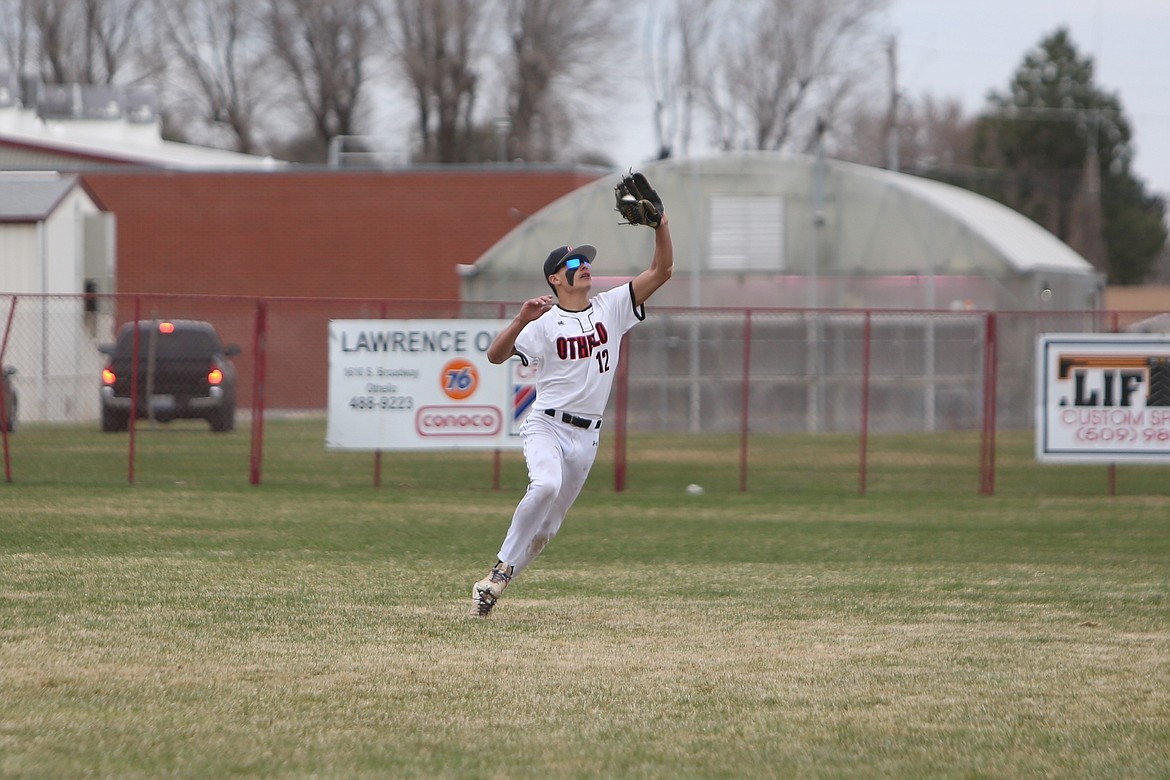 Othello player Xzyan Martinez catches a fly ball in the outfield against Deer Park on Tuesday.