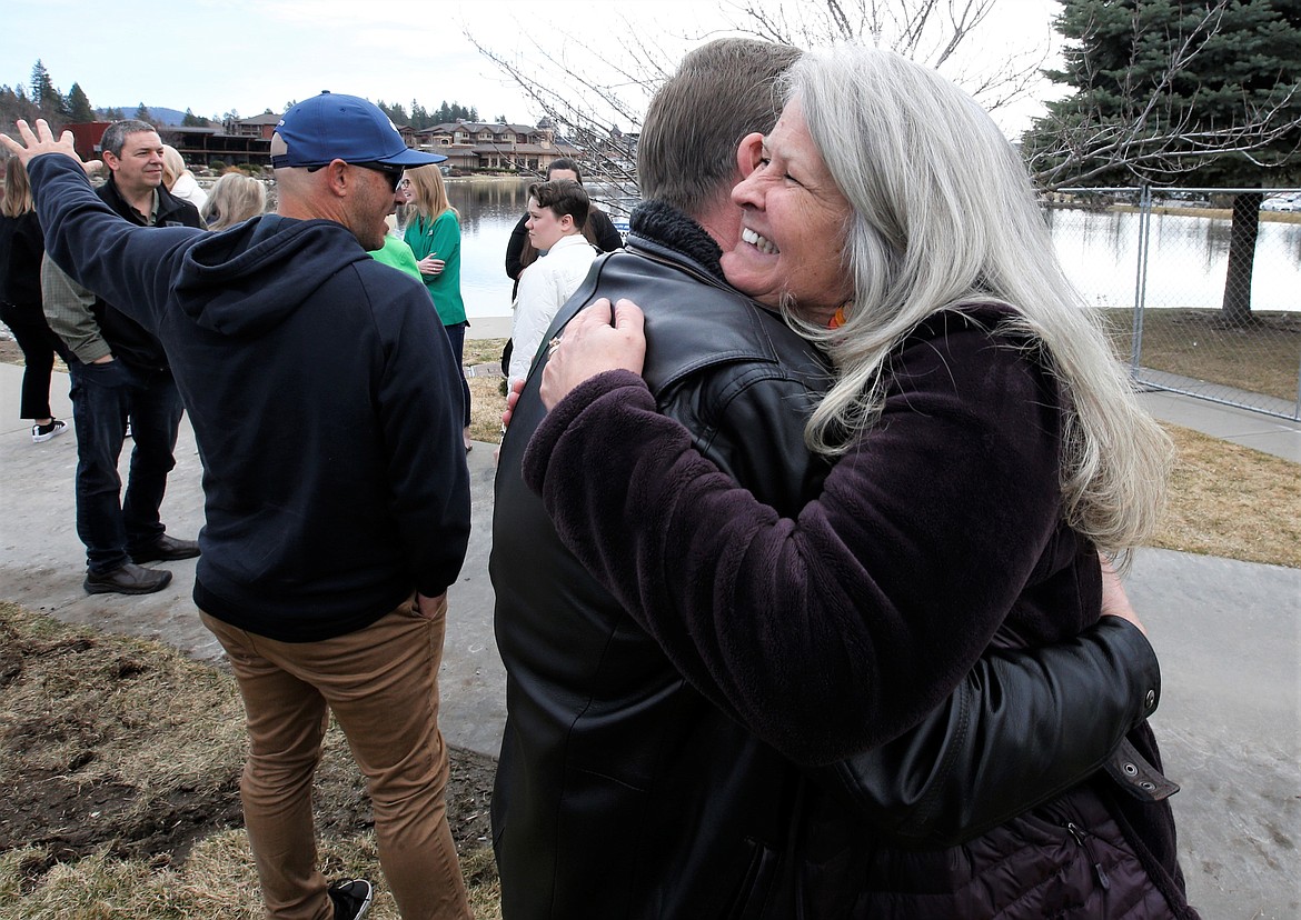 Ali Shute, executive director of the Coeur d’Alene Arts and Culture Alliance, hugs David Denton following the groundbreaking ceremony for the Idaho Central Credit Union Amphitheater at Riverstone Park on Wednesday.