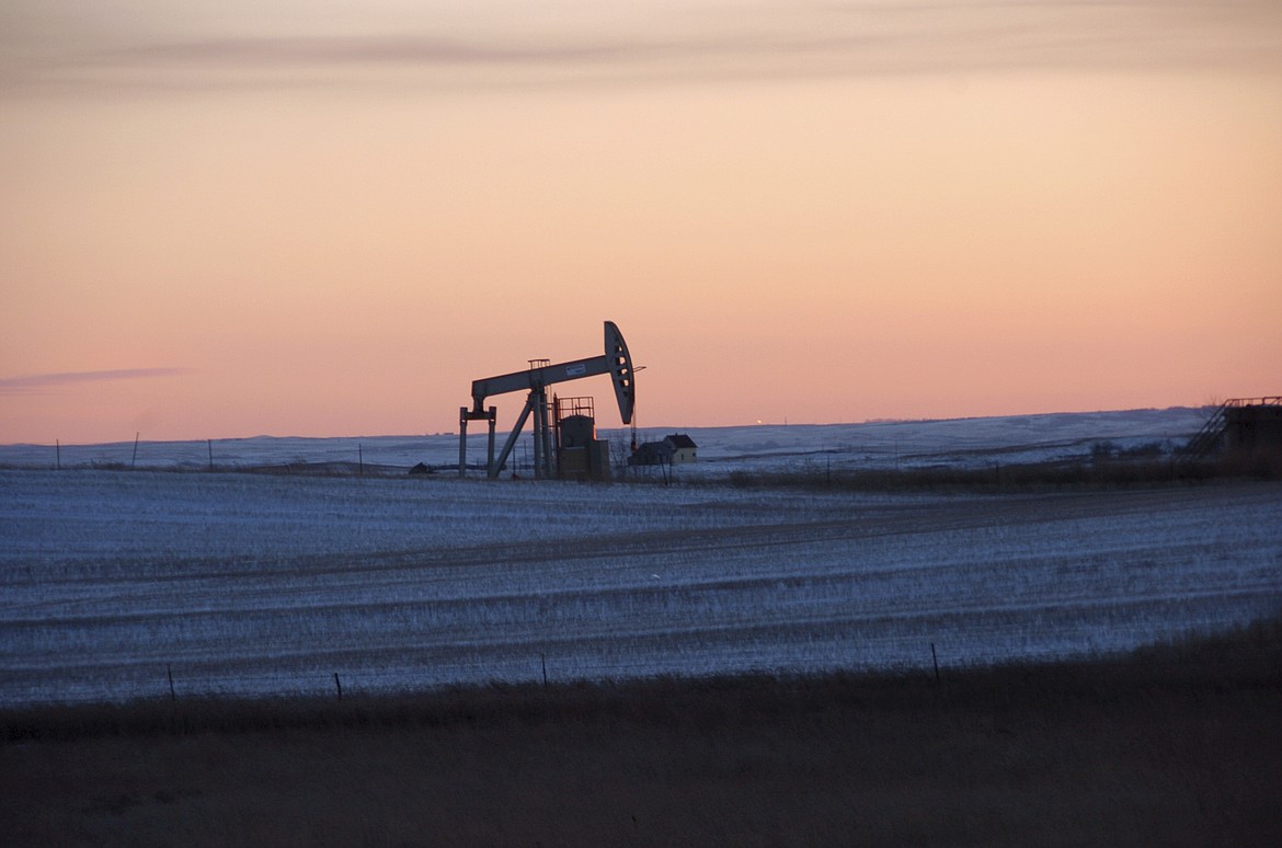 A pump jack for pulling oil from the ground is seen near New Town, N.D., Feb. 25, 2015. On Monday, March 27, 2023, a federal judge ordered the United States government to resume oil and gas lease sales on federal lands in North Dakota as a legal battle continues over the Biden administration's pause on the federal leasing program two years ago in an effort to combat climate change. (AP Photo/Matthew Brown, File)