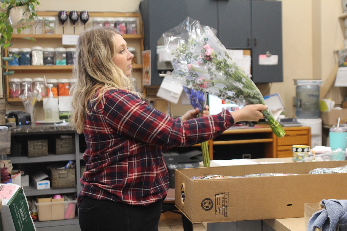 Flower basket co-owner Ashley Ko checks a delivery.