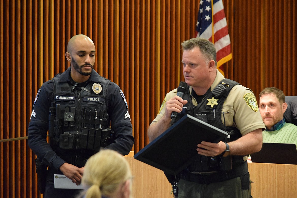 Grant County Sheriff Joe Kriete, right, presenting a citation of meritorious service to Moses Lake Police Cpl. Johnny Mengist at a regular city council meeting on Tuesday.