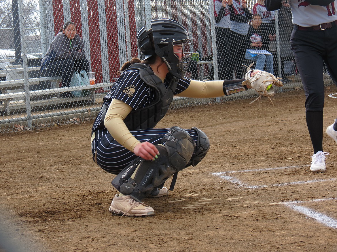 Royal junior Randi Allred catches a pitch at home plate during a Knight game this season. Allred has scored 12 runs this season.