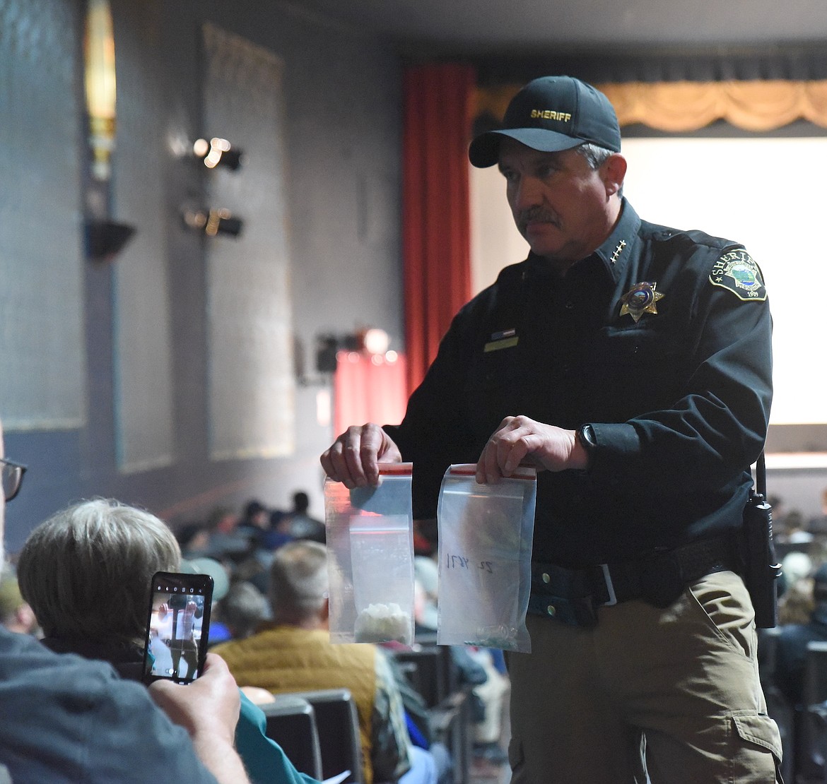 Lincoln County Sheriff Darren Short shows people bags of methamphetamine and fentanyl during a presentation on dangerous drugs Thursday, March 30, at the Dome Theater in Libby. (Scott Shindledecker/The Western News)