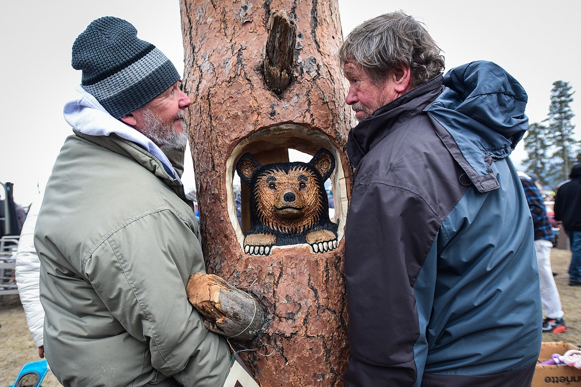 Richard Ford, left, and Sam Teare lift a woodcarving Teare won at the 57th annual Creston Auction on Saturday, April 1. The Creston Auction and Country Fair is the largest annual fundraiser for the all-volunteer Creston Fire Department and has been held in Creston since 1966. (Casey Kreider/Daily Inter Lake)