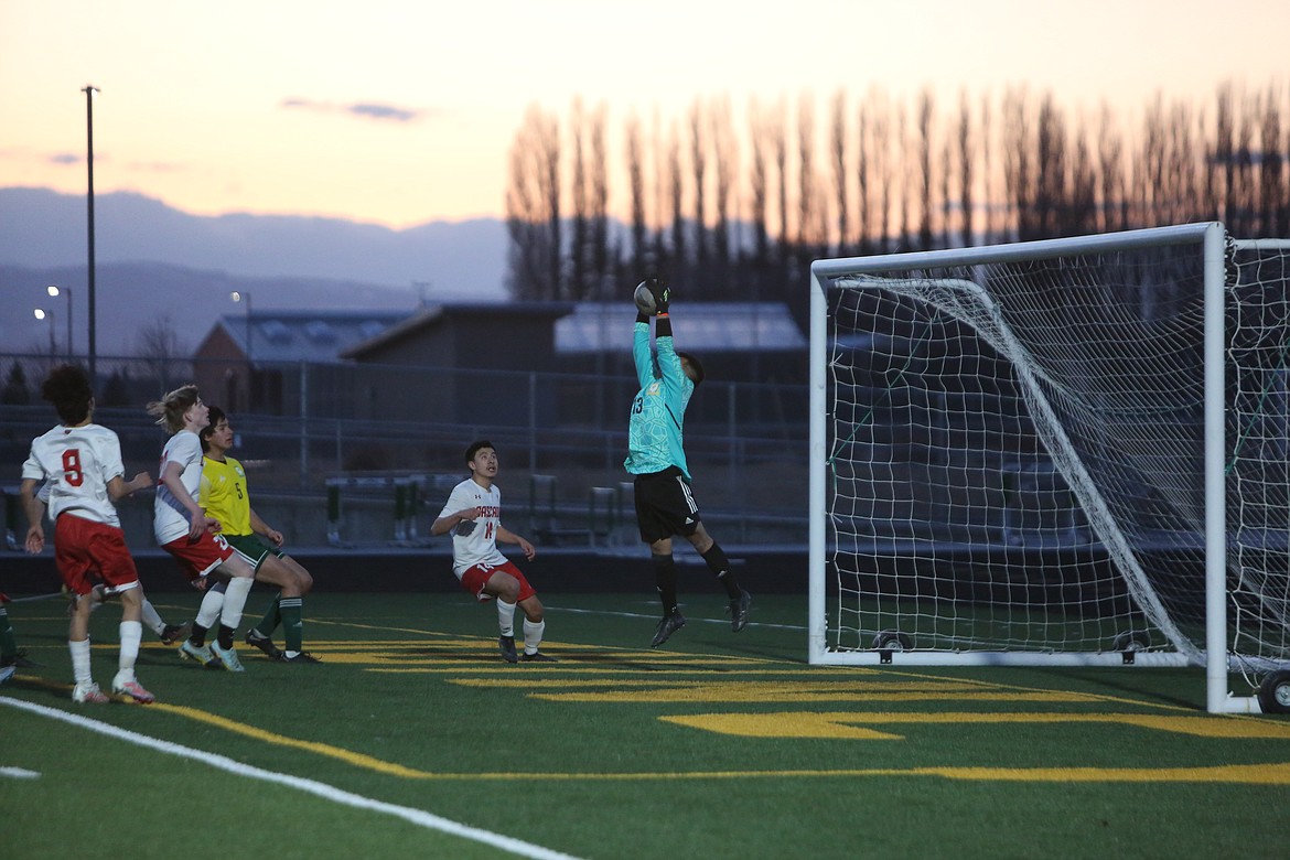 Quincy senior goalkeeper Eduardo Diaz rises up to save a shot against Cascade (Leavenworth) on Thursday.