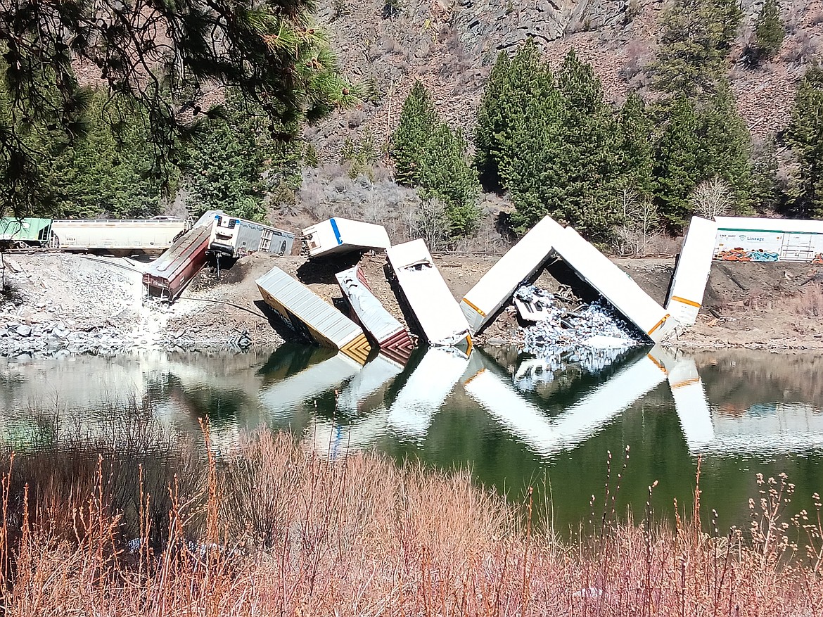 A Montana Rail Link freight train is derailed into the Clark Fork River in Sanders County, Montana on Sunday, April 2, 2023. (Monte Turner/Mineral Independent)