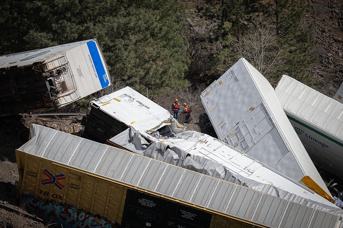 Emergency crews respond to a Montana Rail Link freight train derailment along the Clark Fork River in Sanders County, Montana on Sunday, April 2, 2023. (Tracy Scott/Clark Fork Valley Press)