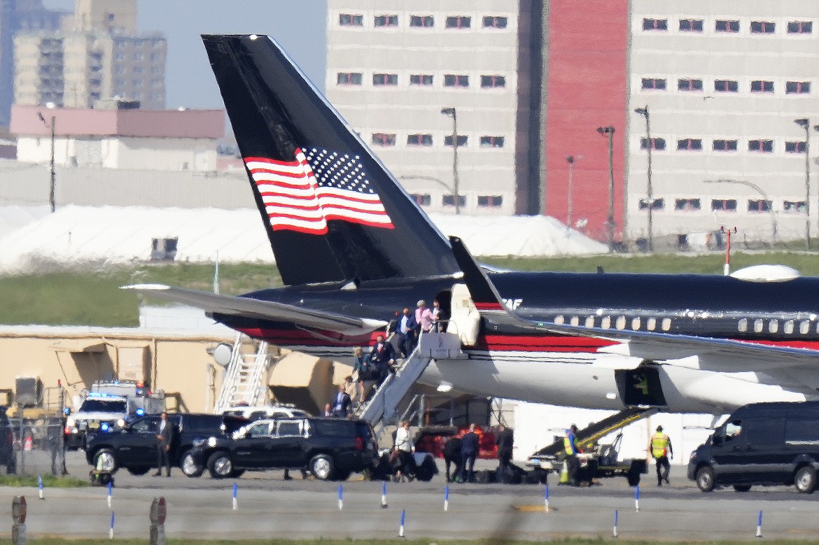 Former President Donald Trump's aides and legal team exit his plane, Monday, April 3, 2023, in New York. Trump arrived in New York on Monday for his expected booking and arraignment the following day on charges arising from hush money payments during his 2016 campaign. (AP Photo/Frank Franklin II)