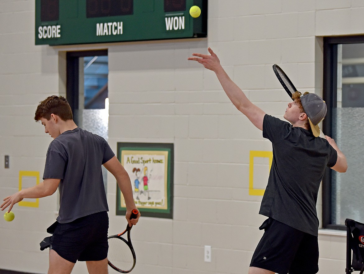 Bulldogs Walt Seigmund, left, and Aydin Mulholland work on their serves at the end of tennis practice in the Muldown gym on March 22. (Whitney England/Whitefish Pilot)