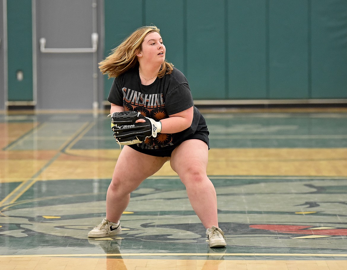 Whitefish junior Billie Melnick catches the ball and looks to throw it to a teammate at softball practice in the WHS gym on Friday, March 24. (Whitney England/Whitefish Pilot)