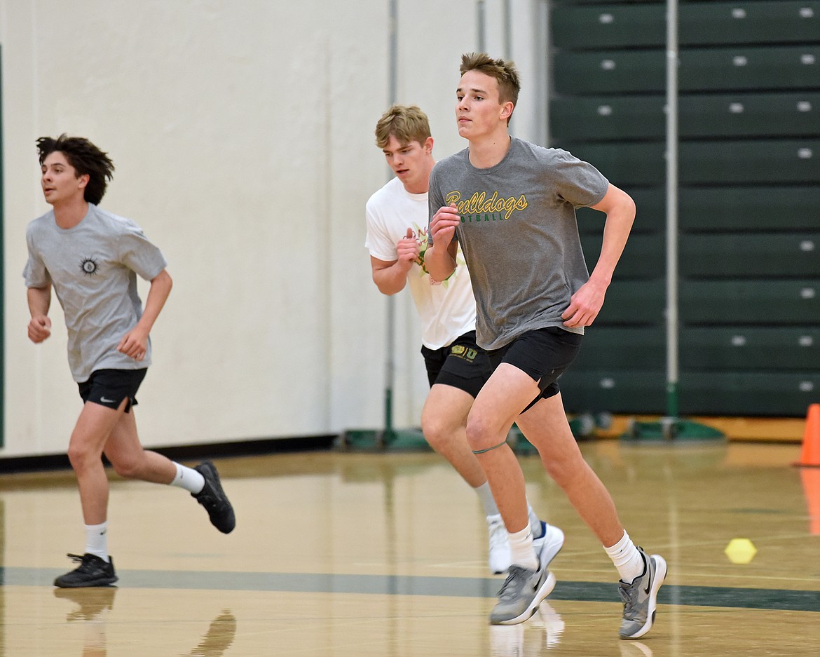 Lucas Ryan, Scott Dalen and Carson Krack practice with the Whitefish track and field team in the WHS gym on March 22. (Whitney England/Whitefish Pilot)