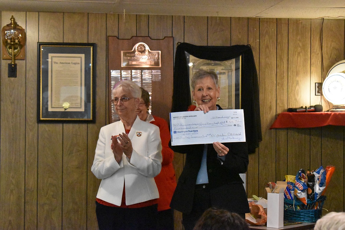 American Legion Auxiliary National President Vickie Koutz accepts a $500 check from  American Legion Post and Unit 28 in Ephrata last week. Koutz is focused on raising money for family members and volunteers that accompany veterans to the National Veterans Creative Arts Festival.