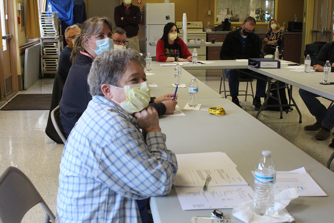 Quincy Valley Medical Center commissioners Sherri Kooy, foreground, and Michele Talley listen to an update on planning for the new hospital at a meeting March 27.