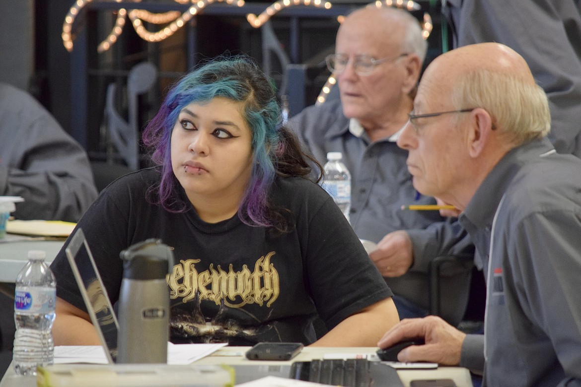 Gisel Badillo waits while AARP Tax-Aide volunteer Roger Nelson prepares her tax return in 2020. The organization is offering help again this year at the Moses Lake and Ephrata senior centers to people of all ages, but senior citizens are prioritized.