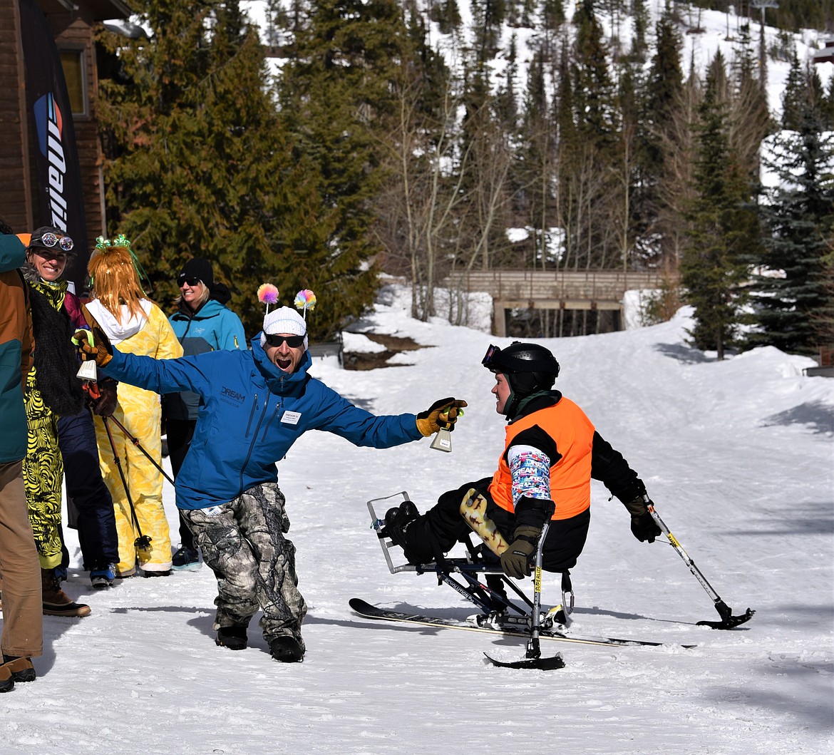 Matt Sather is greeted by Trevor Hildebrand and his cowbells after a day on the slopes during the Shred-a-Thon. (Julie Engler/Whitefish Pilot)