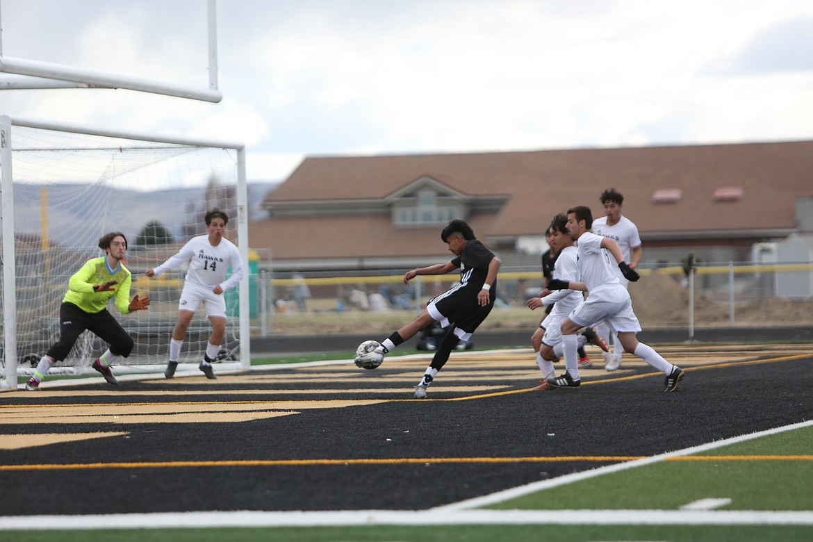 Royal senior Abraham Montoya takes a shot against College Place on March 25.