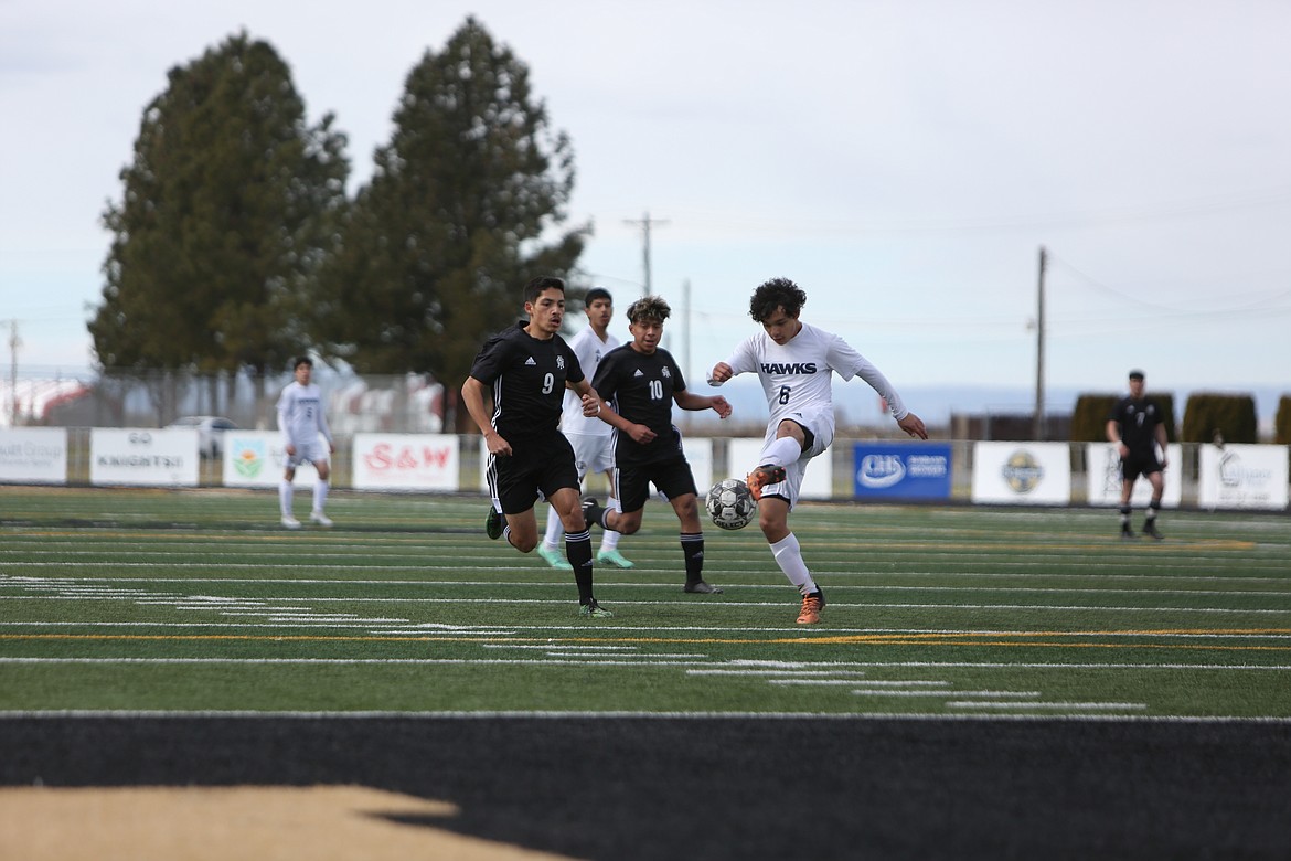 Royal sophomore Silverio Hernandez rushes toward a College Place player with possession of the ball.