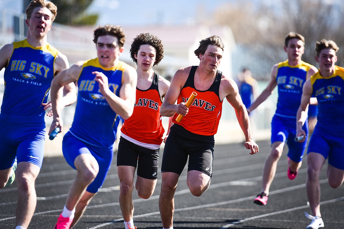Flathead's Trevor Burke takes the baton from Dustyn Franchini-White in the boys 400 meter relay during a track meet with Whitefish and Missoula Big Sky at Legends Stadium on Tuesday, April 4. (Casey Kreider/Daily Inter Lake)