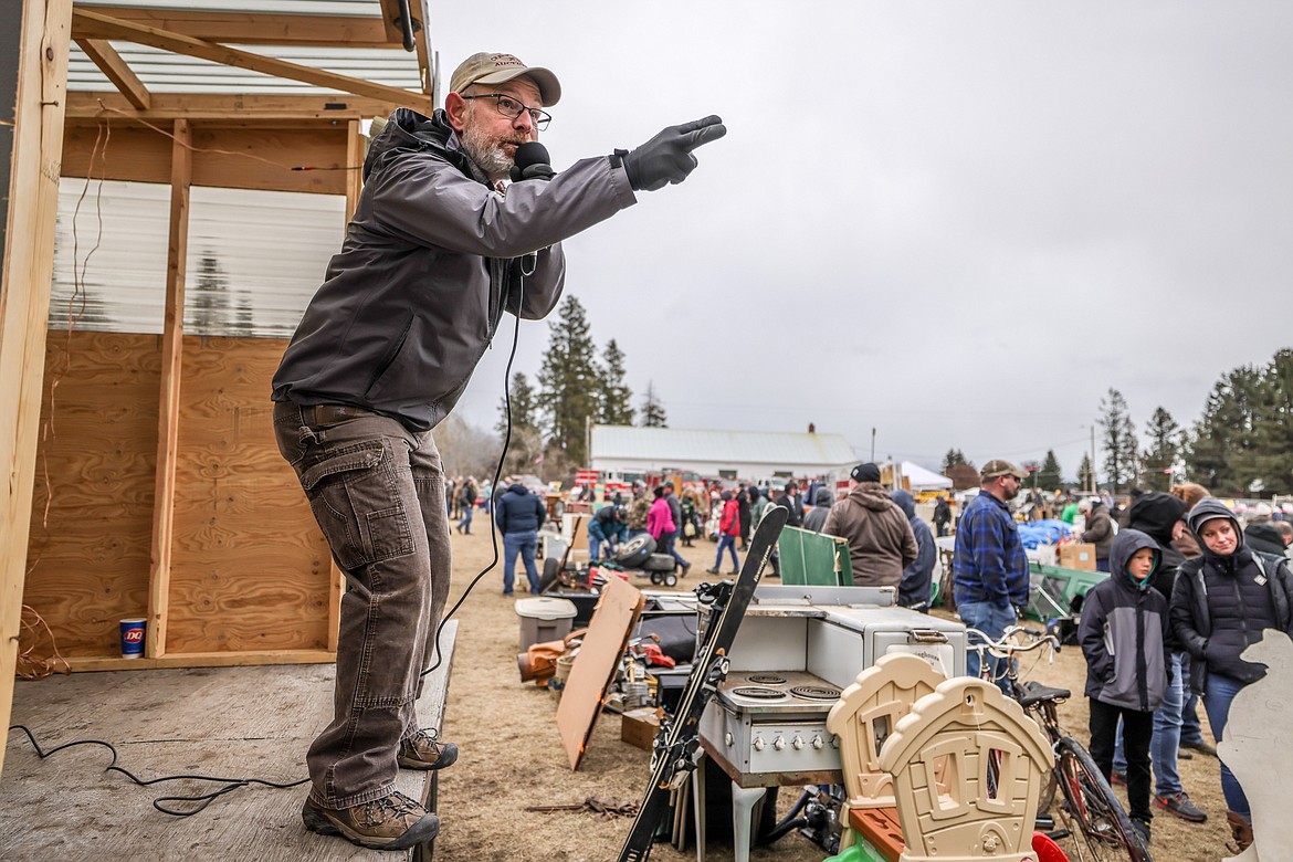 An auctioneer takes bids at the Creston Auction on Saturday. (JP Edge photo)