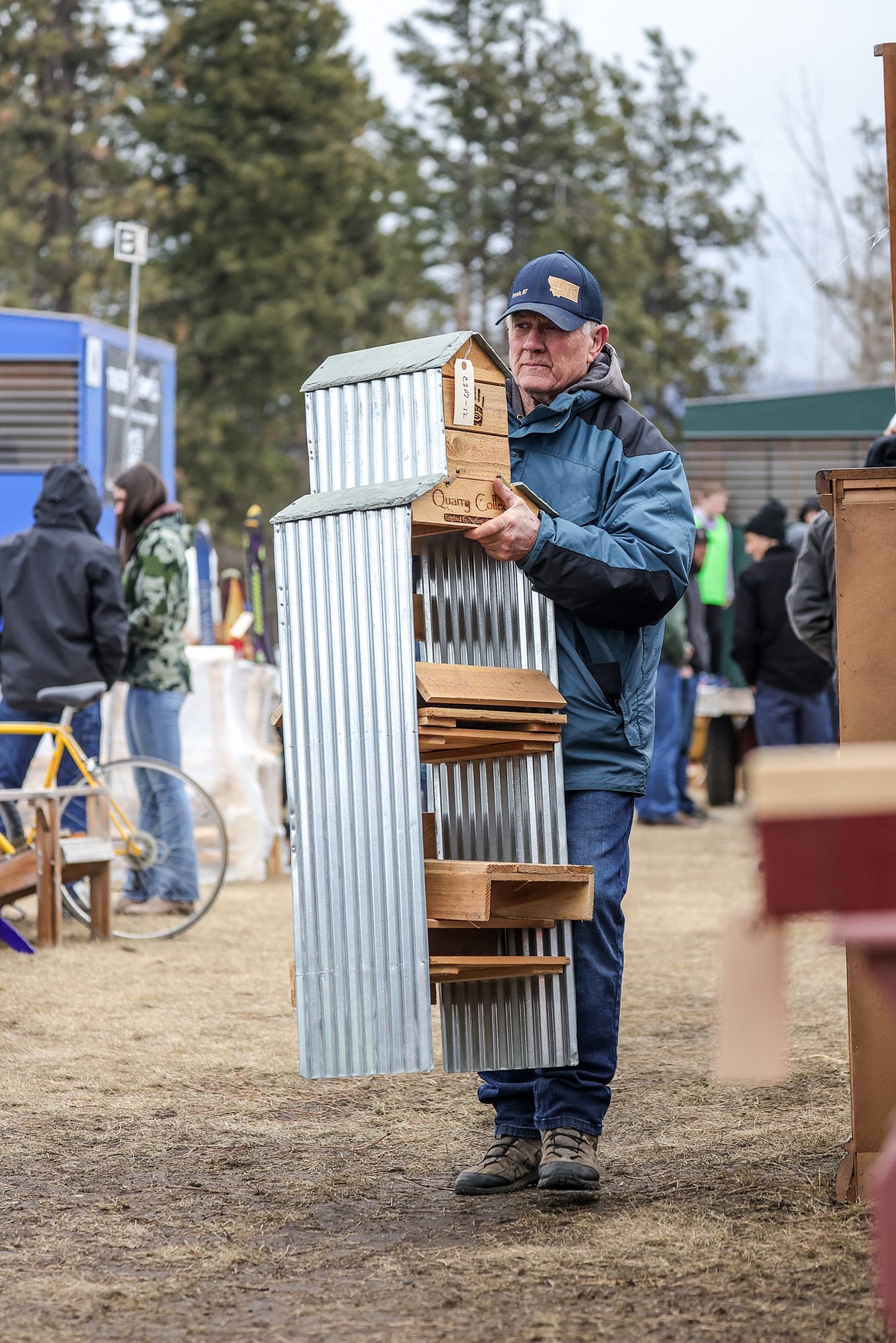 Ben Harbour of Ovando picks up a shelf for his wife's new shop, Red Shed Gifts. (JP Edge photo)