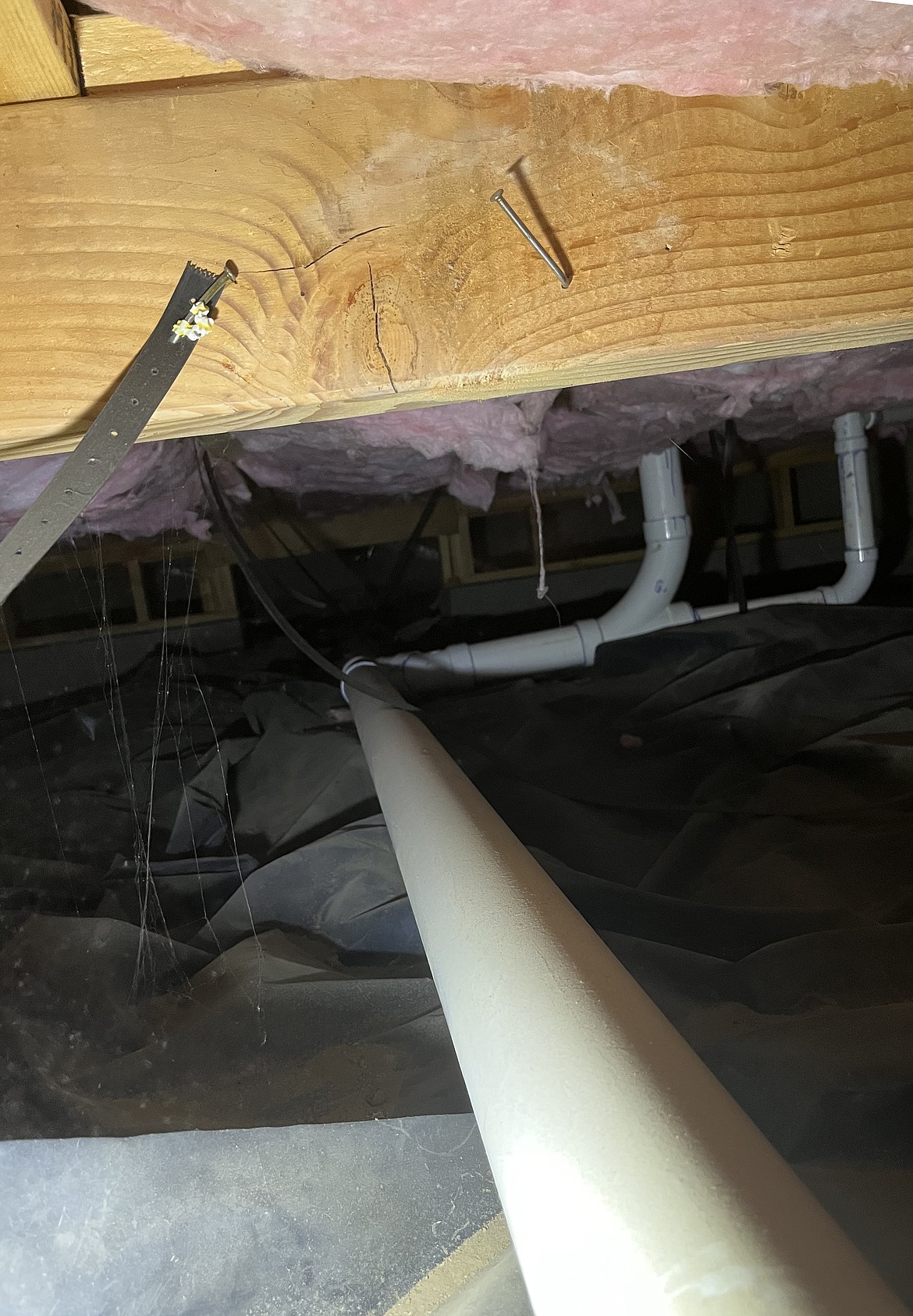 In this crawl space under a house, the strap on the left has been cut, leaving the drain pipe unsupported. This can lead to bad drainage, Counter said.