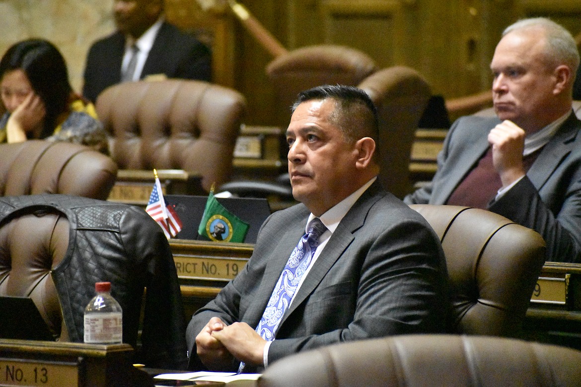 Ybarra, at his desk on the House floor, listens to some of the dialog about different bills and amendments proposed for consideration.