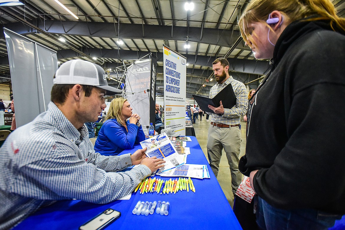 Garrett Tutvedt and Amanda Jackson with CHS Mountain West Co-op speak with job-seekers at the NWMT Job & Opportunity Fair inside the Trade Center at the Flathead County Fairgrounds on Thursday, April 6. (Casey Kreider/Daily Inter Lake)