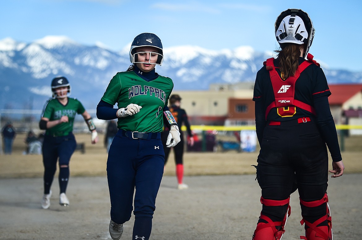 Glacier's Brooklyn Imperato (1) crosses the plate with Nakiah Persinger (8) rounding third after a hit by Emma Cooke (11) in the second inning against Missoula Hellgate at Glacier High School on Thursday, April 6. (Casey Kreider/Daily Inter Lake)