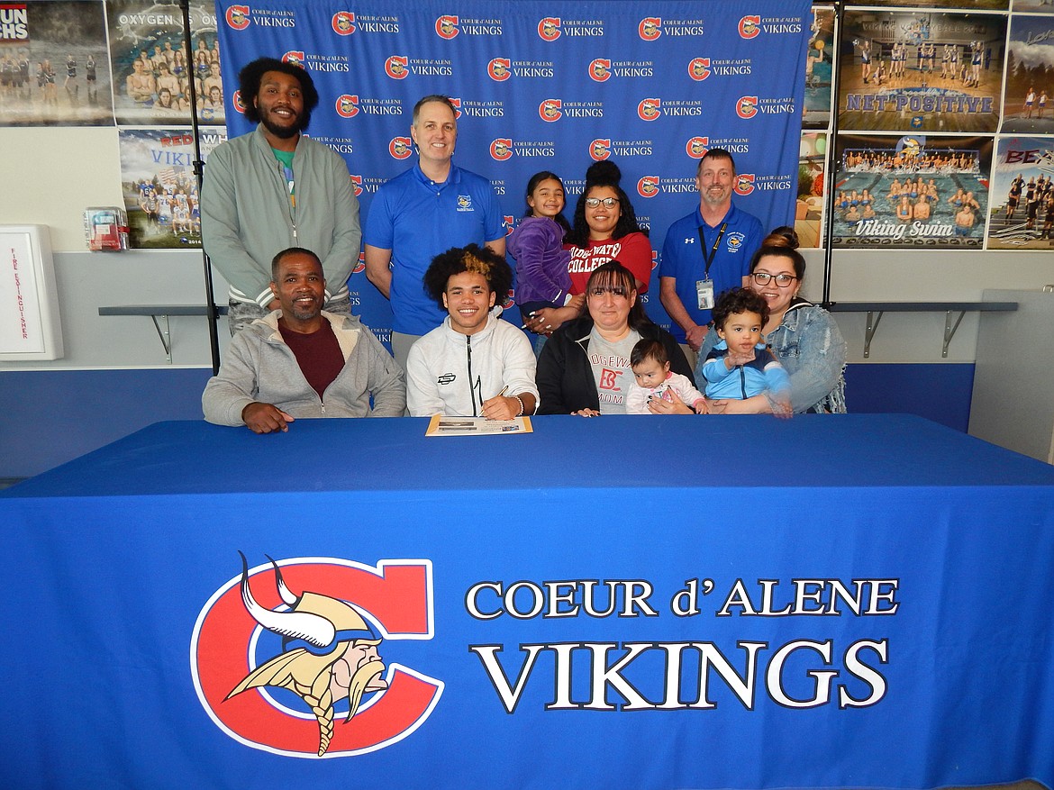 Courtesy photo
Coeur d'Alene High senior Steven Burgess Jr. recently signed a letter of intent to play basketball at NCAA Division III Bridgewater (Va.) College. Seated from left are Steve Burgess Sr, (dad); Steven Burgess Jr., Diana Burgess (mom) holding Capri Dickerson (niece), and Neena Dickerson (aunt) holding Carmelo Dickerson (nephew); and standing from left, Chris Dickerson, uncle; Jon Adams, Coeur d'Alene High head boys basketball coach; Sydney Burgess (sister) holding Cali Dickerson (niece), and Bill White, Coeur d'Alene High athletic director.