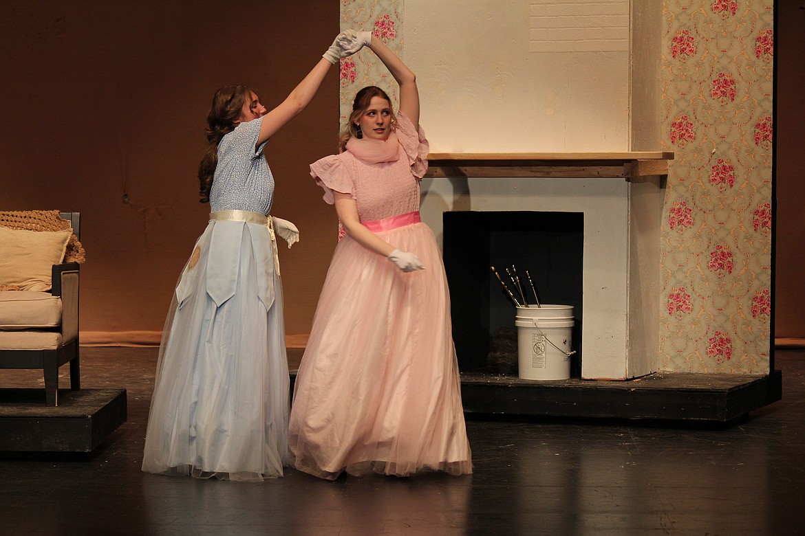 Jo (Madeline O’Neil), left, and Meg (Evan Arledge), right, practice their steps before the ball in the musical number “Delighted.” The story of the March sisters premieres Friday at Moses Lake High School