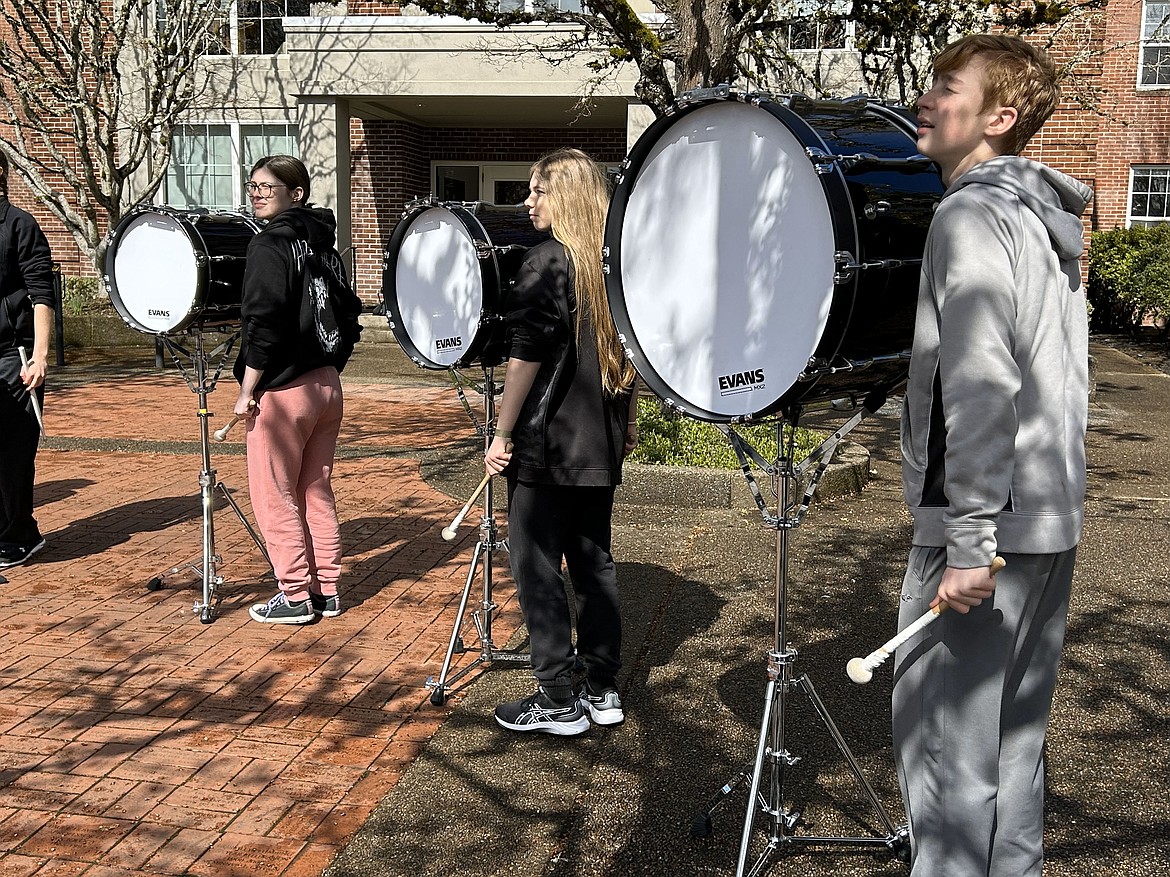 The bass drum players ready themselves for a high-energy performance.