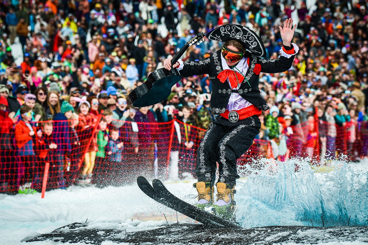 A competitor in a mariachi costume successfully completes a trip across the water  at Whitefish Mountain Resort's pond skim on Saturday, April 8. (Casey Kreider/Daily Inter Lake)