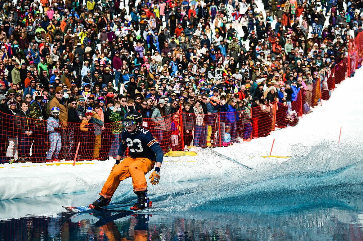 A competitor successfully carves across the water on skis at Whitefish Mountain Resort's pond skim on Saturday, April 8. (Casey Kreider/Daily Inter Lake)