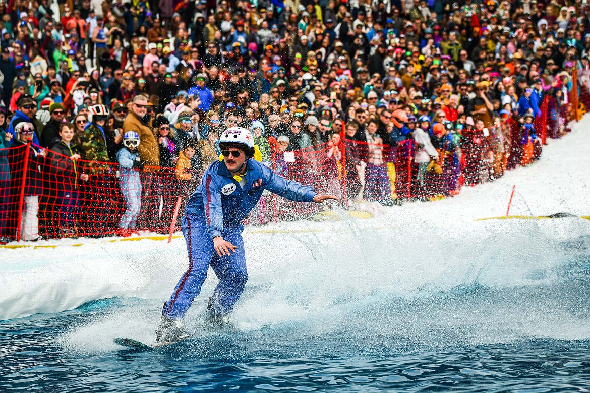 Competitors launch themselves across the water on skis or snowboards at Whitefish Mountain Resort's pond skim on Saturday, April 8. (Casey Kreider/Daily Inter Lake)