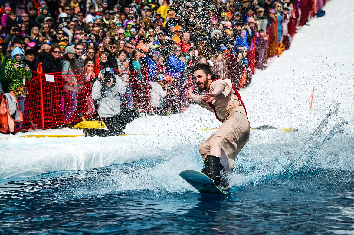 A competitor successfully completes a trip across the water  at Whitefish Mountain Resort's pond skim on Saturday, April 8. (Casey Kreider/Daily Inter Lake)