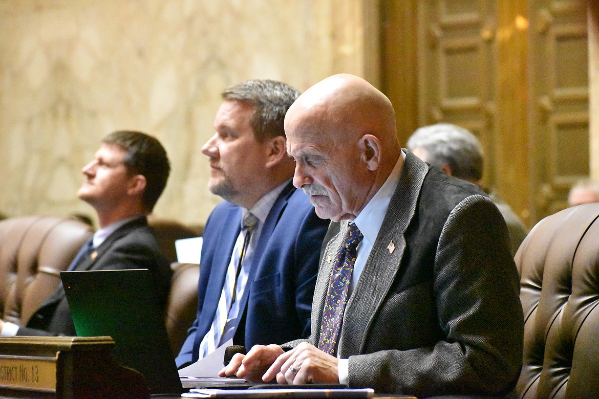 Representative Tom Dent (R-Moses Lake), right, sits next to Rep. Sam Low (R-Lake Stevens), left, on the House Floor, to whom he is a mentor.