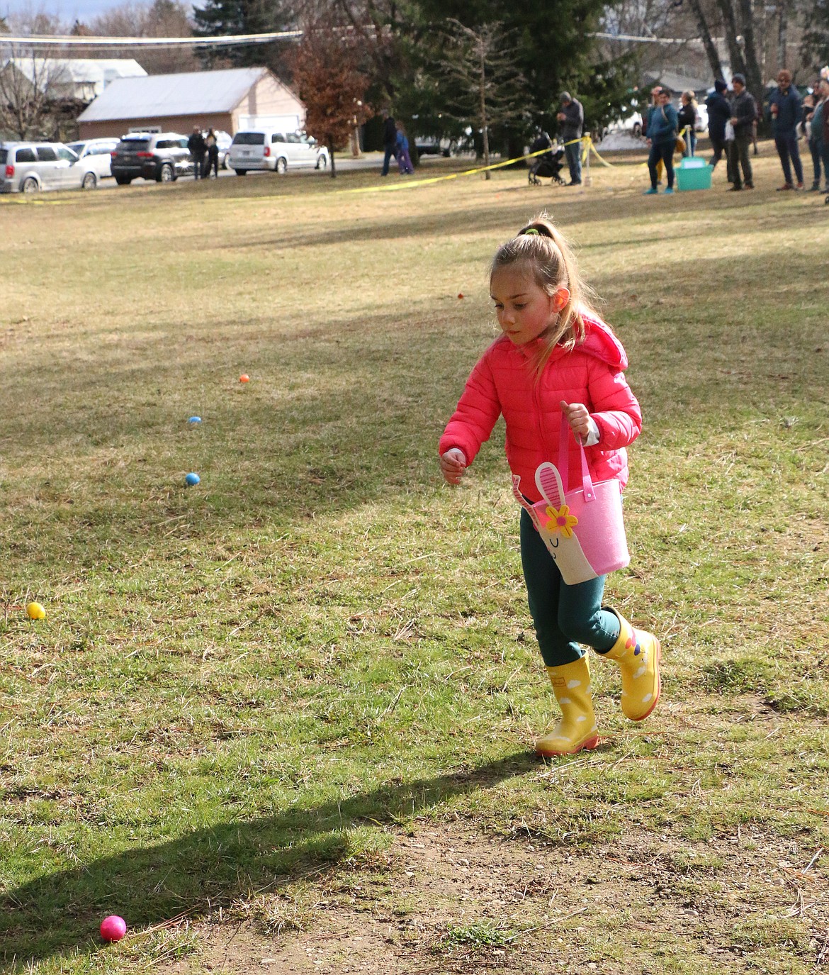 A youngster races toward a few of the thousands of candy-filled Easter eggs at the Sandpoint Lions annual Easter egg hunt at Lakeview Park on Saturday.