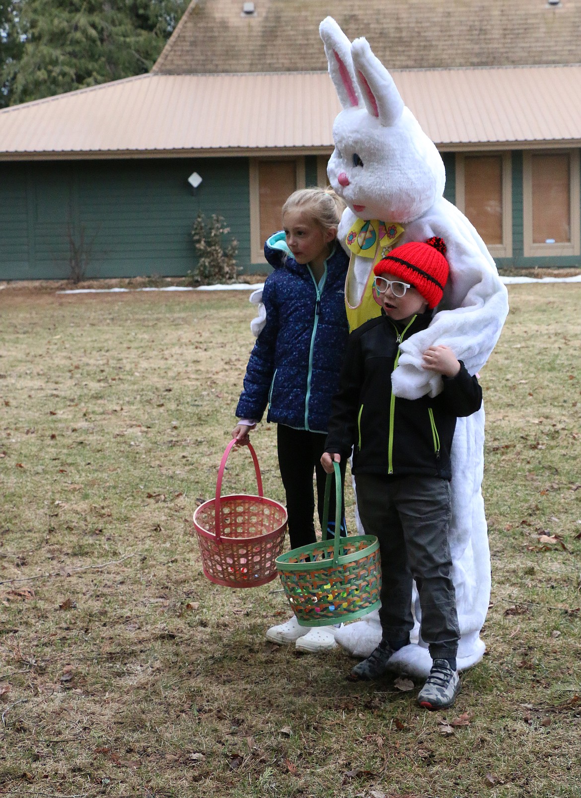 A pair get their photo taken with the Easter Bunny during the Sandpoint Lions annual Easter egg hunt at Lakeview Park on Saturday.