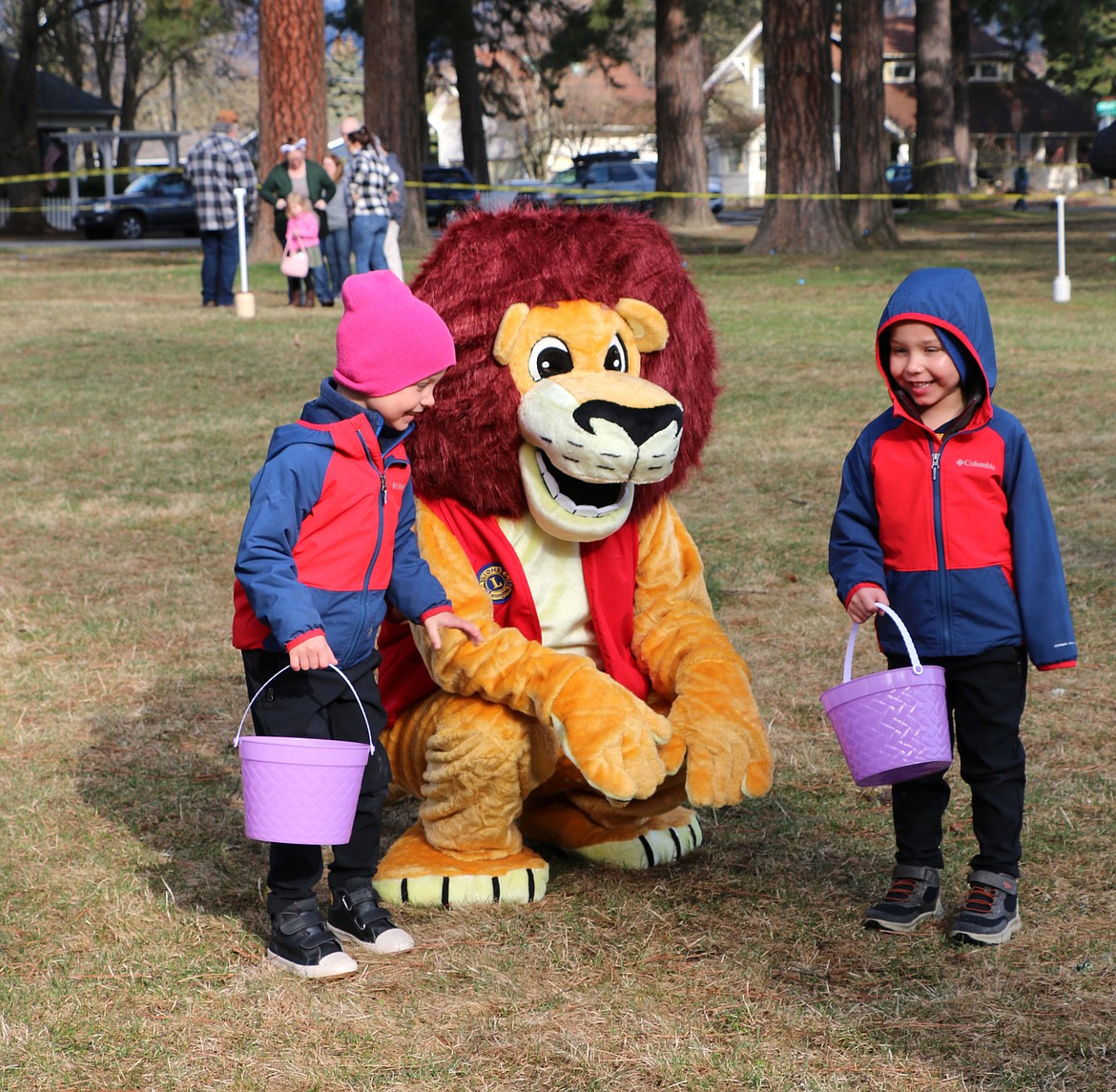A pair of Easter egg hunters get their picture taken with Melvin the Lion, the new mascot of the Sandpoint Lions Club.