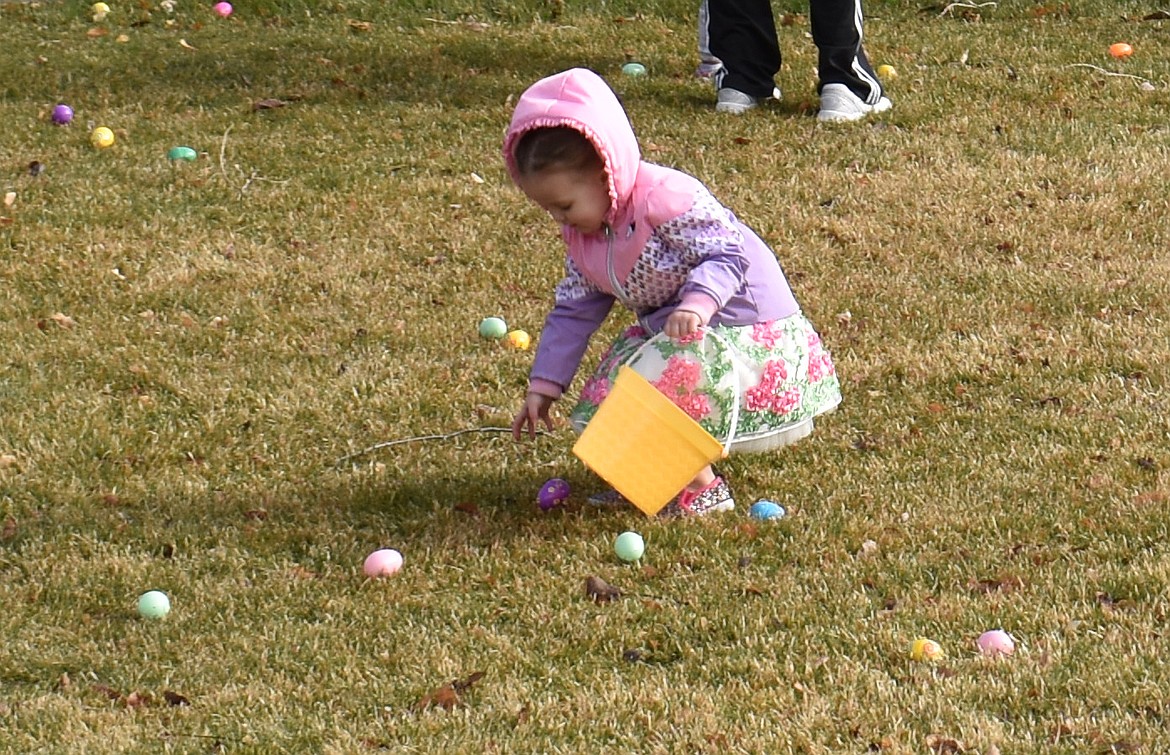 Blakely Gayle Van Dyke, 2, picks up an egg at the George Easter egg hunt Saturday.