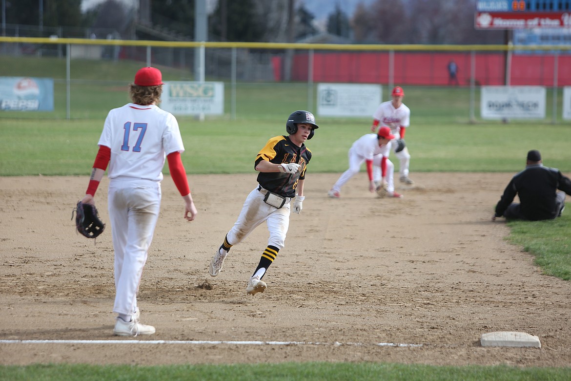 Moses Lake junior Jayce Stuart, in black, runs to third base during the first game of Friday’s doubleheader against Eastmont.