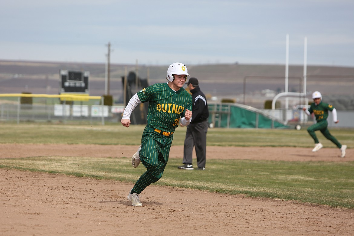 Quincy senior Kenny Thompson dashes toward third base during the top of the sixth inning against Royal on Saturday morning.