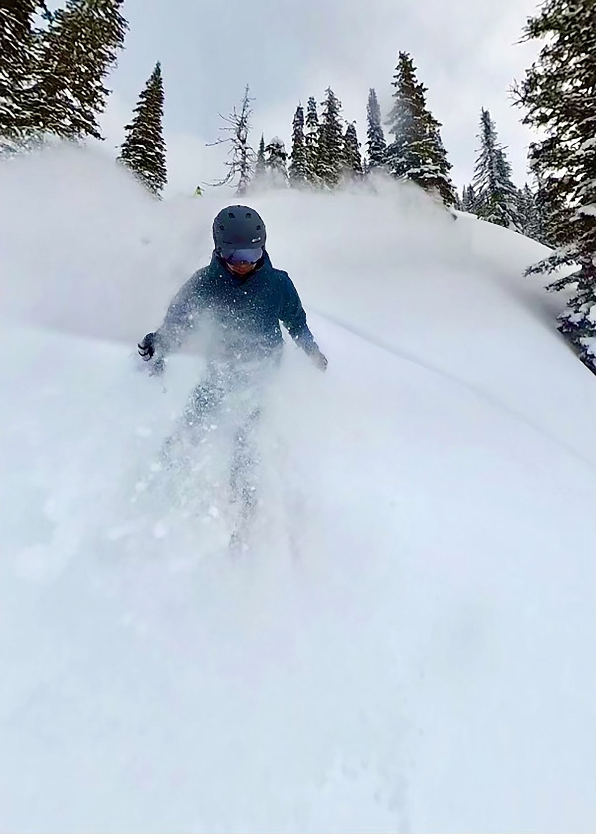 A skier dances in the powder during a Selkirk Powder backcountry trip.
