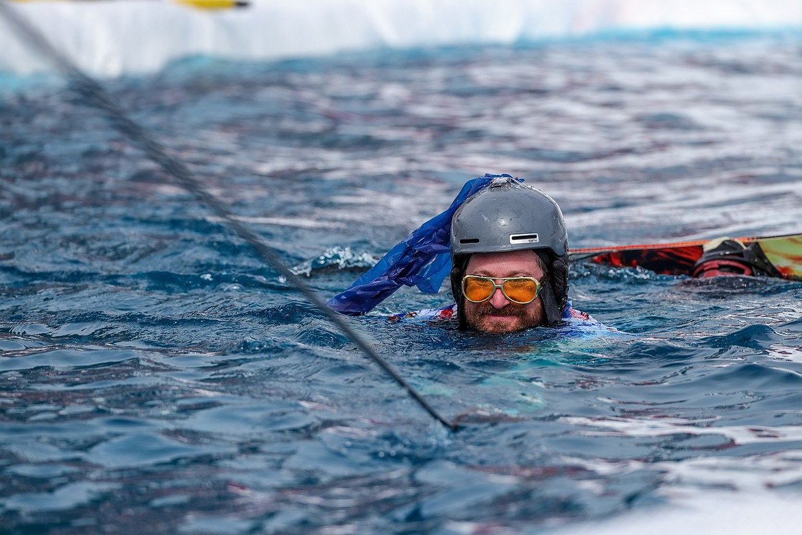 A competitor is pulled to shore after falling in the cold water. (JP Edge photo)